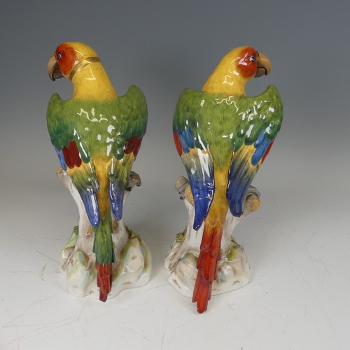 365 - A pair of 20thC continental porcelain Parrots, modelled perched on a tree, underglaze blue mark to b... 