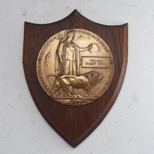 A WW1 Devonshire memorial Plaque 'Death Penny', awarded to the family of 'William Ernest Wynn', mounted on wooden shield.