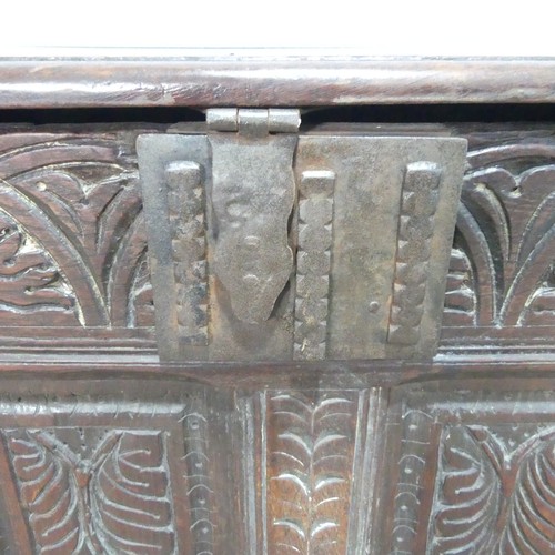 457 - A 17th century and later oak Coffer, rectangular plank top over 17th century carved panels, raised o... 