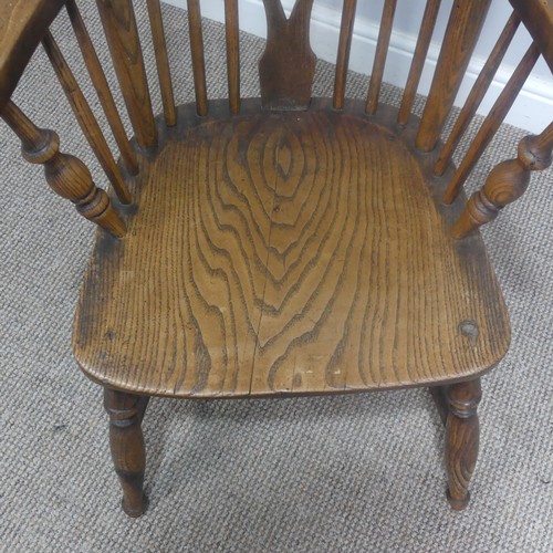 465 - An antique ash and elm windsor Armchair, legs cuts down and with old metal repairs, W 57 cm x H 85 c... 