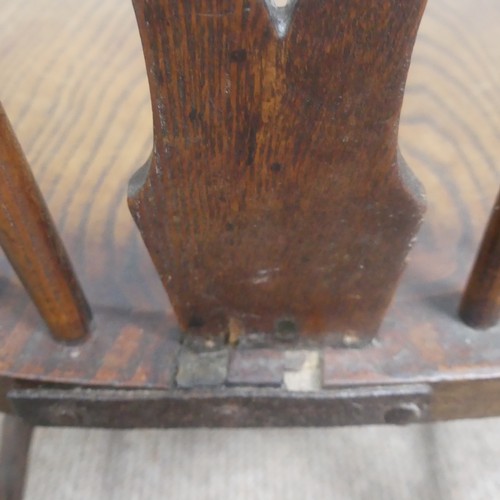 465 - An antique ash and elm windsor Armchair, legs cuts down and with old metal repairs, W 57 cm x H 85 c... 