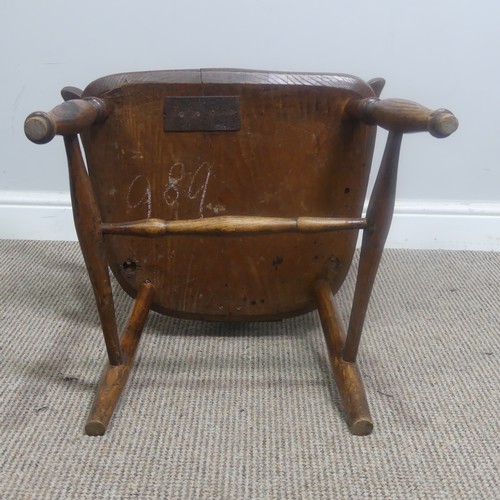 465 - An antique ash and elm windsor Armchair, legs cuts down and with old metal repairs, W 57 cm x H 85 c... 