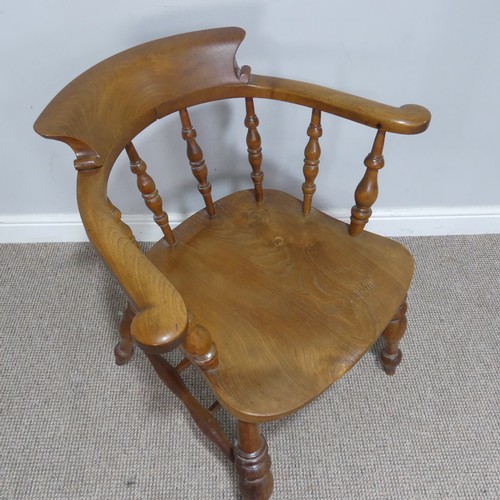 480 - An early 20th century ash and elm Captains / Smokers Bow Armchair, W 66 cm x H 77 cm x D 60 cm.... 