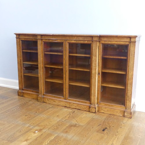 494 - A good Victorian burr walnut breakfront glazed Bookcase, shaped top over glazed doors and plinth bas... 