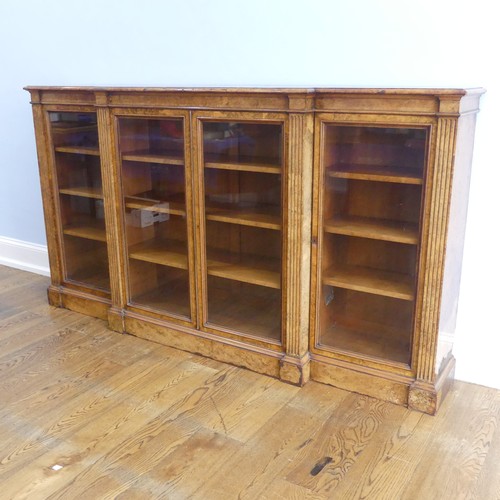 494 - A good Victorian burr walnut breakfront glazed Bookcase, shaped top over glazed doors and plinth bas... 