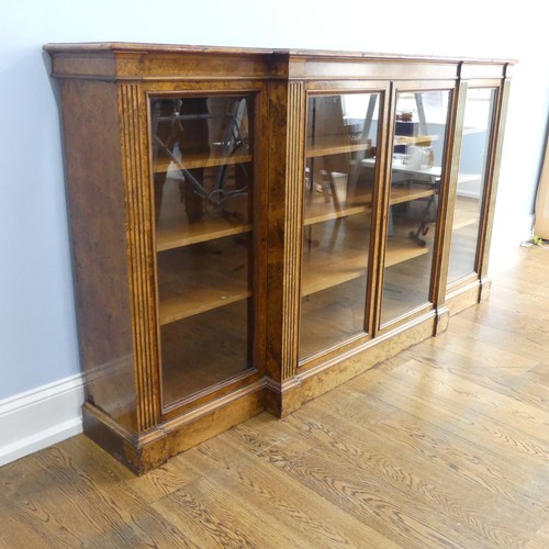 494 - A good Victorian burr walnut breakfront glazed Bookcase, shaped top over glazed doors and plinth bas... 