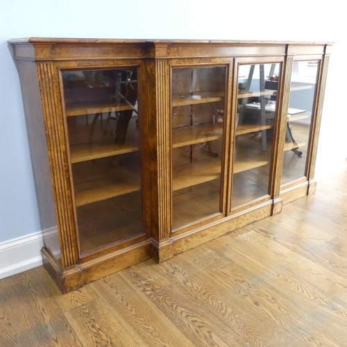 494 - A good Victorian burr walnut breakfront glazed Bookcase, shaped top over glazed doors and plinth bas... 