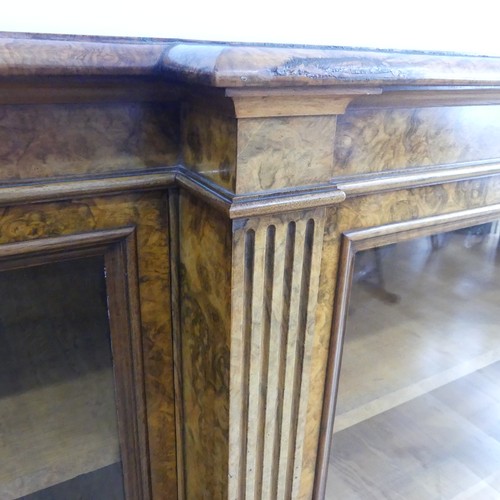 494 - A good Victorian burr walnut breakfront glazed Bookcase, shaped top over glazed doors and plinth bas... 