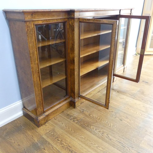 494 - A good Victorian burr walnut breakfront glazed Bookcase, shaped top over glazed doors and plinth bas... 