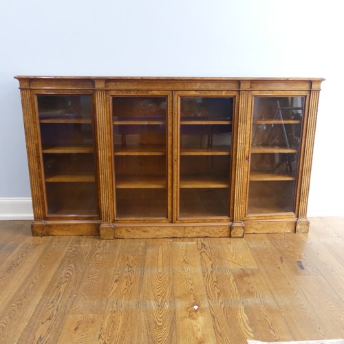 494 - A good Victorian burr walnut breakfront glazed Bookcase, shaped top over glazed doors and plinth bas... 