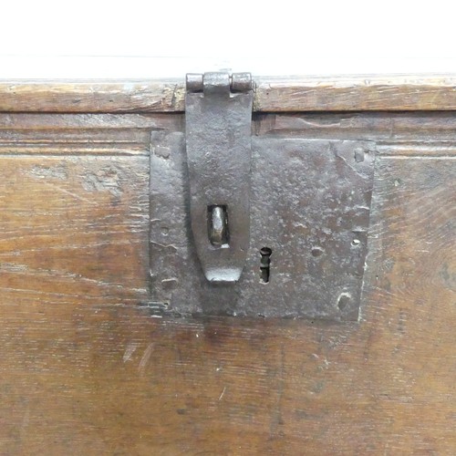 498 - An 18th century oak Coffer, rectangular top with replacement hinges, raised on end supports, W 131 c... 