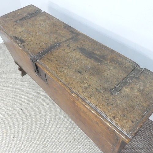 498 - An 18th century oak Coffer, rectangular top with replacement hinges, raised on end supports, W 131 c... 