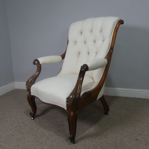 563 - A Victorian mahogany open Armchair, upholstered button back and scroll arms, above serpentine front ... 