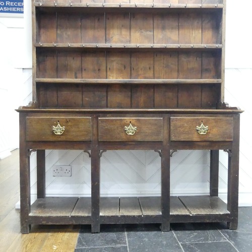 503 - A George III oak Dresser with plate rack, moulded cornice over frieze with hooks, above three panel ... 