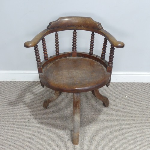 522 - A late 19th century ash and elm Smokers elbow swivel desk Chair, turned column back rests, over circ... 