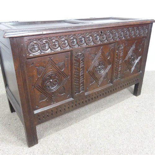 533 - A 17th century oak Coffer, two panelled rectangular top with original pin hinges, over three carved ... 