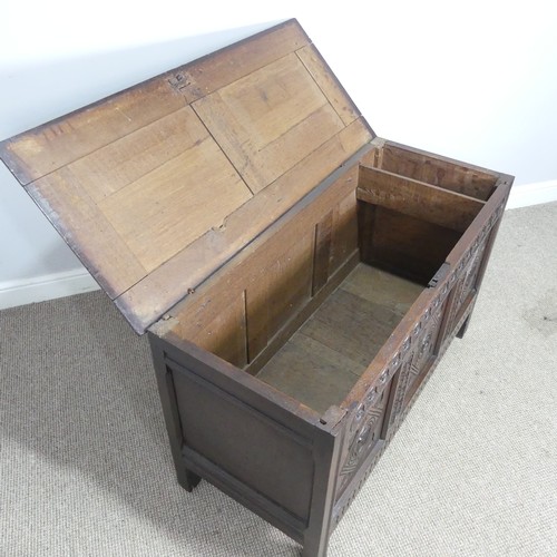 533 - A 17th century oak Coffer, two panelled rectangular top with original pin hinges, over three carved ... 