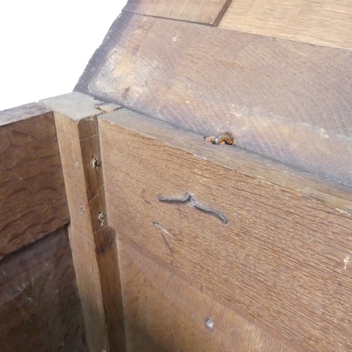 533 - A 17th century oak Coffer, two panelled rectangular top with original pin hinges, over three carved ... 