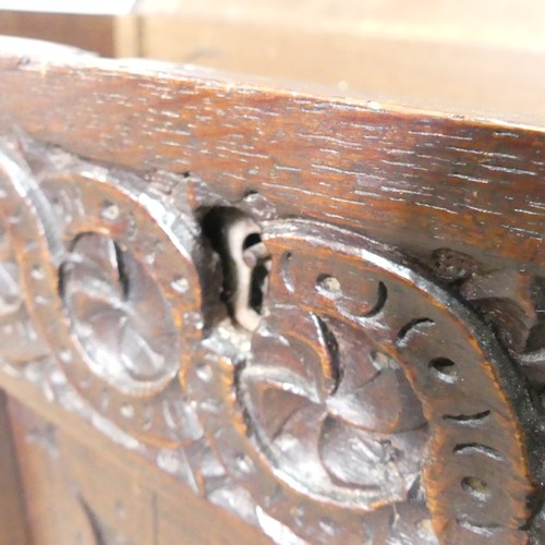 533 - A 17th century oak Coffer, two panelled rectangular top with original pin hinges, over three carved ... 