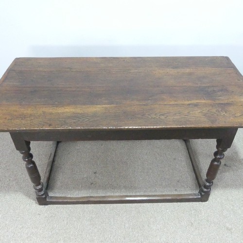 537 - An 18th century oak farmhouse Table, four planked top with cleated ends, raised on turned legs and s... 