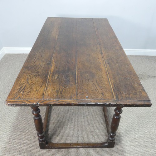 537 - An 18th century oak farmhouse Table, four planked top with cleated ends, raised on turned legs and s... 