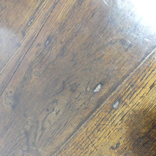 537 - An 18th century oak farmhouse Table, four planked top with cleated ends, raised on turned legs and s... 