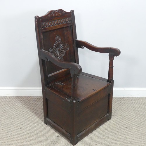 538 - An antique probably 17th century oak wainscot box seat Armchair, carved backrest flanked by scrolled... 