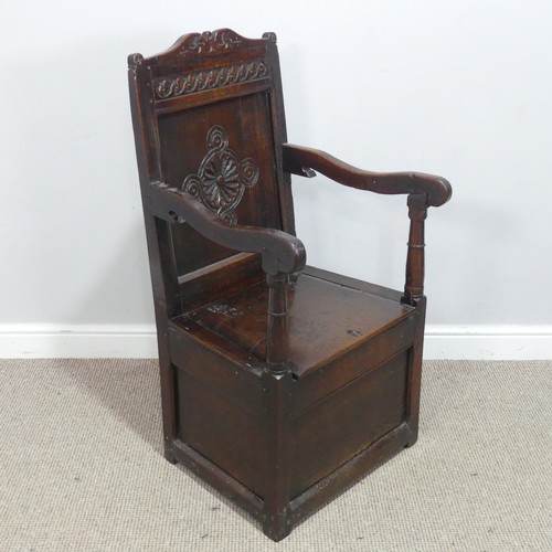 538 - An antique probably 17th century oak wainscot box seat Armchair, carved backrest flanked by scrolled... 