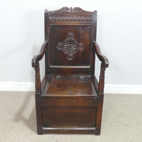 538 - An antique probably 17th century oak wainscot box seat Armchair, carved backrest flanked by scrolled... 