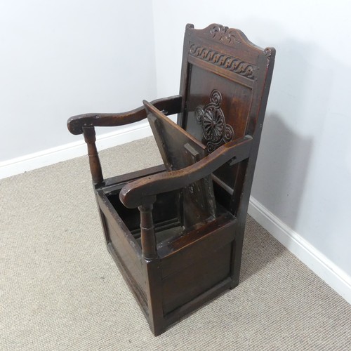 538 - An antique probably 17th century oak wainscot box seat Armchair, carved backrest flanked by scrolled... 