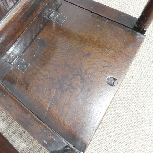 538 - An antique probably 17th century oak wainscot box seat Armchair, carved backrest flanked by scrolled... 