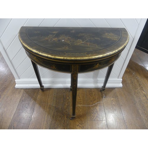 548 - An early 20th century Chinoiserie demi lune card Table, black lacquered and painted gilt decorations... 