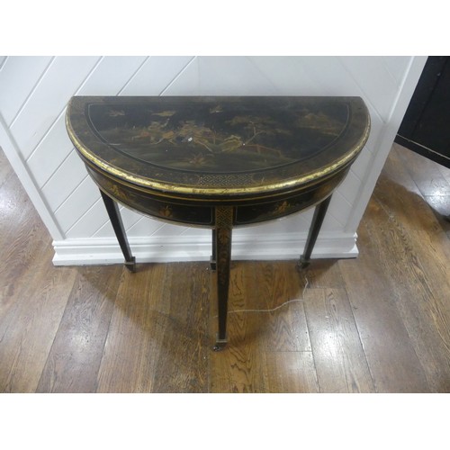 548 - An early 20th century Chinoiserie demi lune card Table, black lacquered and painted gilt decorations... 