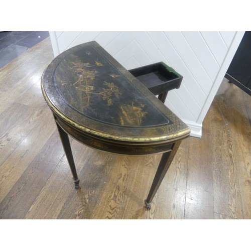 548 - An early 20th century Chinoiserie demi lune card Table, black lacquered and painted gilt decorations... 