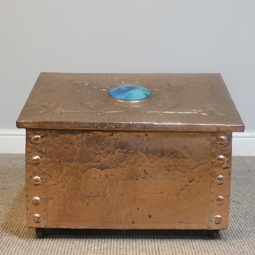 525 - An Arts and Crafts copper fireside / log Box, sloped hinge top with very large central cabochon / ru... 