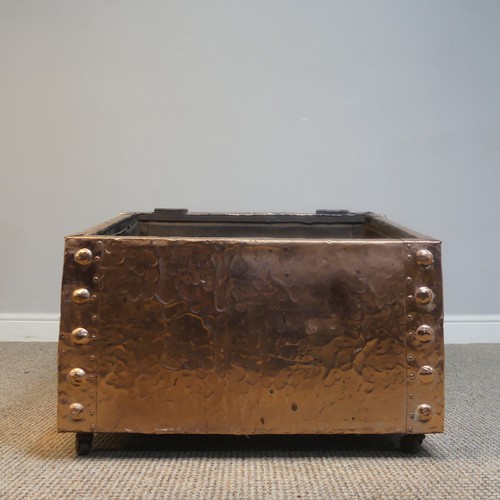 525 - An Arts and Crafts copper fireside / log Box, sloped hinge top with very large central cabochon / ru... 