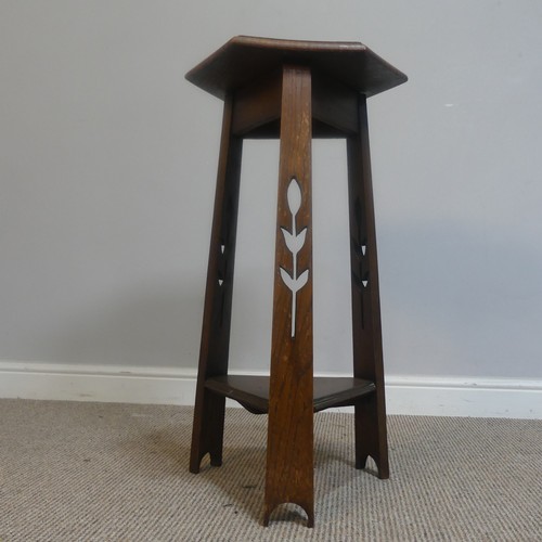 568 - An Arts and Crafts oak hexagonal Plant Stand, raised on three pierced supports and triangular under-... 