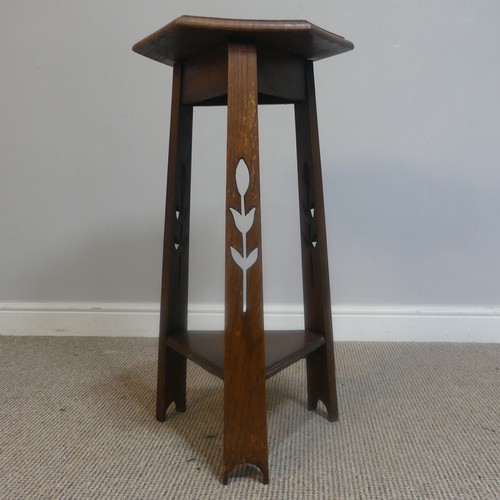 568 - An Arts and Crafts oak hexagonal Plant Stand, raised on three pierced supports and triangular under-... 