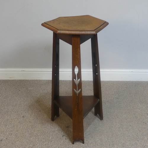 568 - An Arts and Crafts oak hexagonal Plant Stand, raised on three pierced supports and triangular under-... 