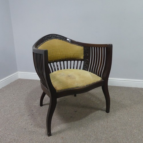 431 - An Edwardian mahogany tub Armchair, with spindle back and arm rests, above serpentine front upholste... 