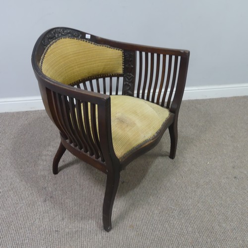 431 - An Edwardian mahogany tub Armchair, with spindle back and arm rests, above serpentine front upholste... 