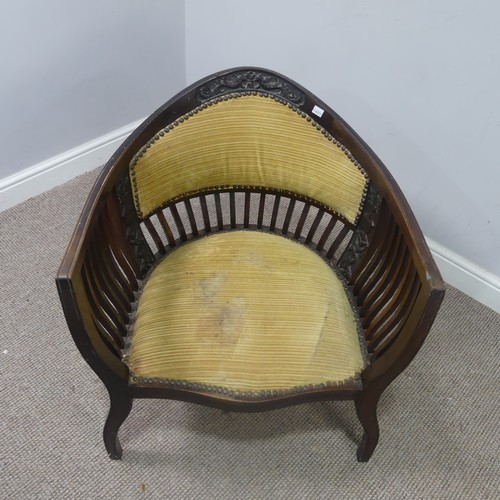 431 - An Edwardian mahogany tub Armchair, with spindle back and arm rests, above serpentine front upholste... 