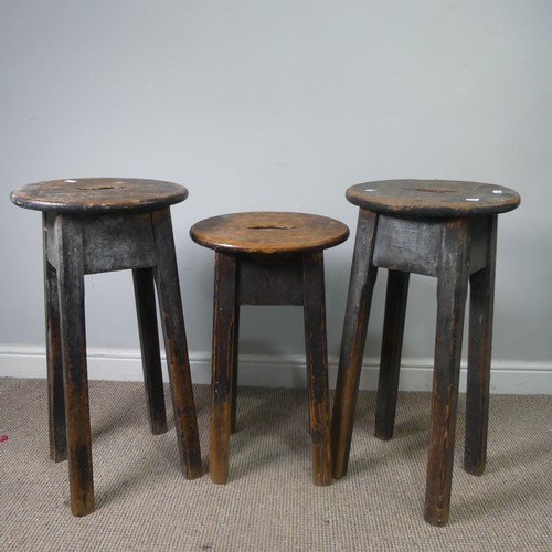 427 - Three antique stained pine kitchen Stools, with oval tops and pierced handles, raised on chamfered s... 