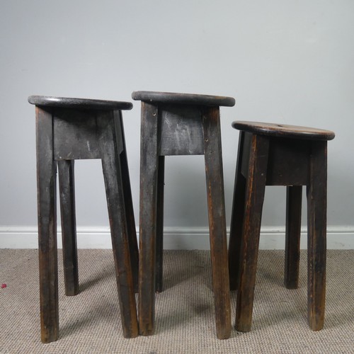 427 - Three antique stained pine kitchen Stools, with oval tops and pierced handles, raised on chamfered s... 