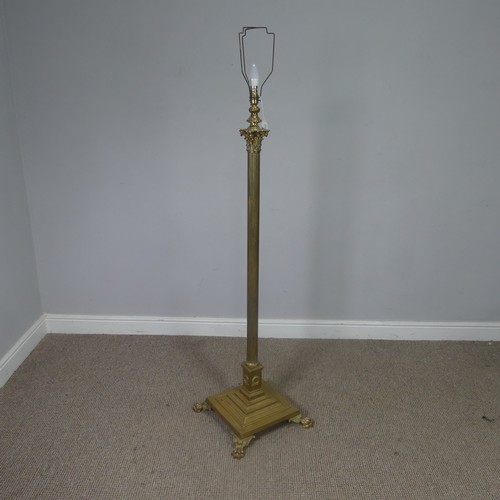 470 - An antique brass standard Lamp, electrified, with corinthian column raised on stepped base and claw ... 