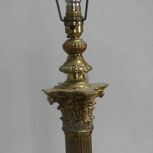 470 - An antique brass standard Lamp, electrified, with corinthian column raised on stepped base and claw ... 