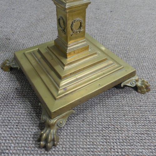 470 - An antique brass standard Lamp, electrified, with corinthian column raised on stepped base and claw ... 