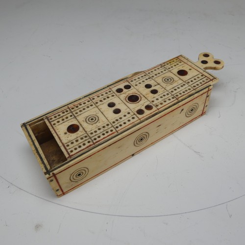 177 - An early 19th century French Prisoner of War carved bone Games Box, the sliding cover pierced for cr... 