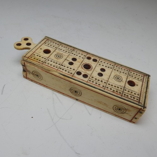 177 - An early 19th century French Prisoner of War carved bone Games Box, the sliding cover pierced for cr... 