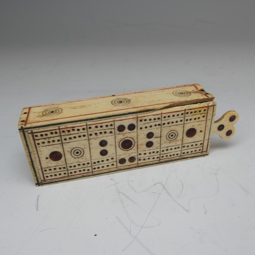 177 - An early 19th century French Prisoner of War carved bone Games Box, the sliding cover pierced for cr... 